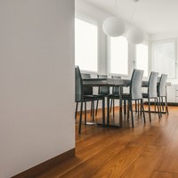 Residenza Trento  - Grigio e bianco sposano il caldo color cognac del Teak Parkemo, levigato a poro aperto e oliato naturale a campione. Un